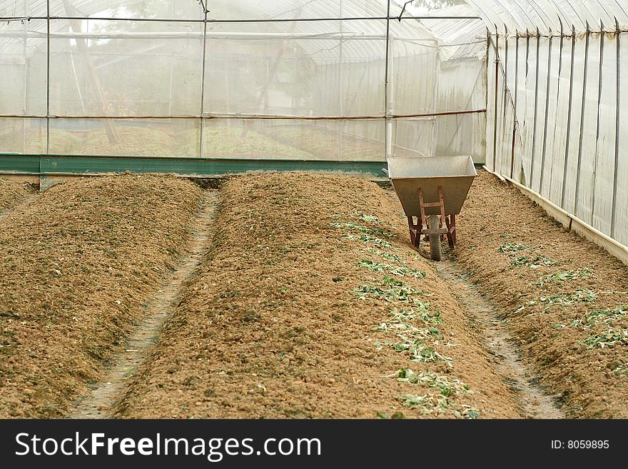 Empty farm and wheel barrow