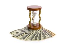 Dollars And Hourglass On White. Royalty Free Stock Image