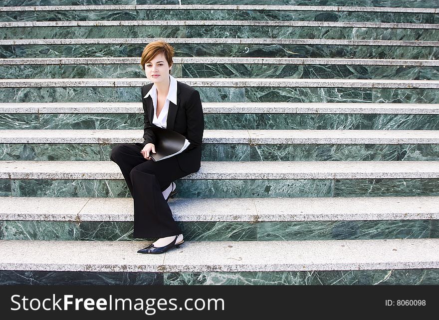 Young businesswoman over marble steps background.