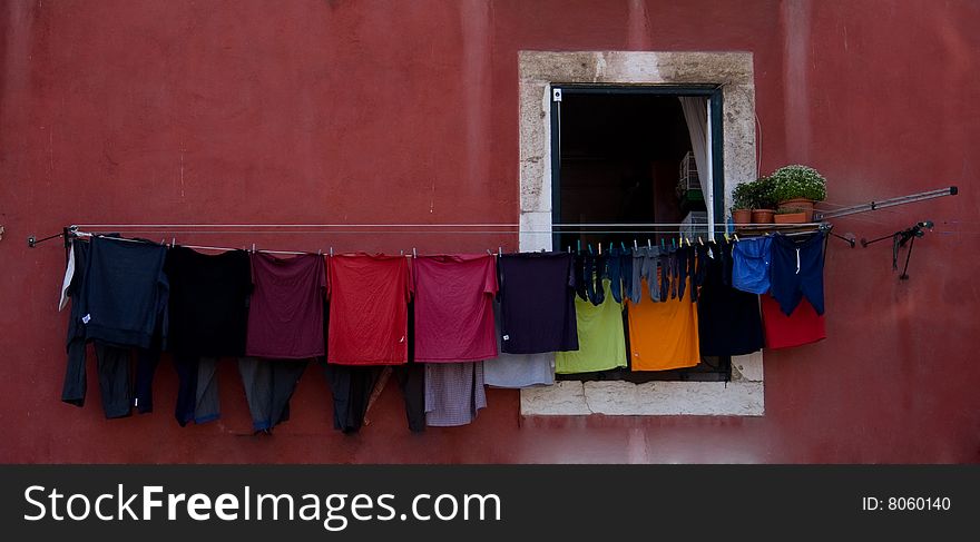Old building with clothes hanging from a line over the window. Old building with clothes hanging from a line over the window