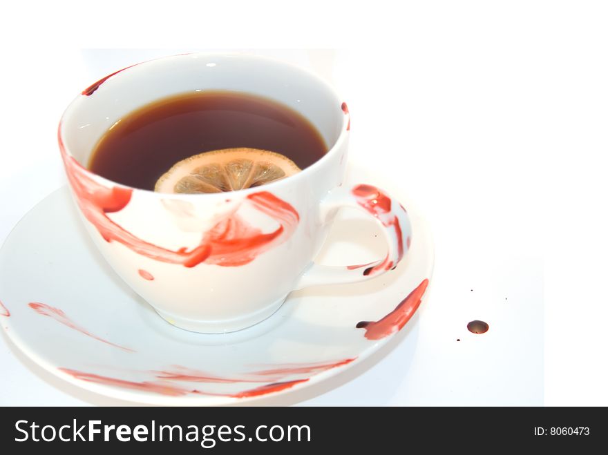 Cup of tea with blood smeared around it. Tea has lemon in it. Can be used for any drink hot drink isolated on white. Cup of tea with blood smeared around it. Tea has lemon in it. Can be used for any drink hot drink isolated on white