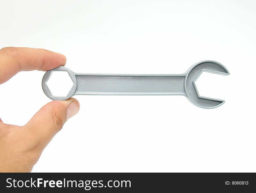 Tool in two fingers on white background. photo image. Tool in two fingers on white background. photo image