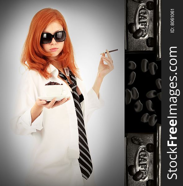 Young red-haired girl in the dress of the secretary poses with a coffee cup. Pictures well approach for advertising of coffee and cafe. Young red-haired girl in the dress of the secretary poses with a coffee cup. Pictures well approach for advertising of coffee and cafe