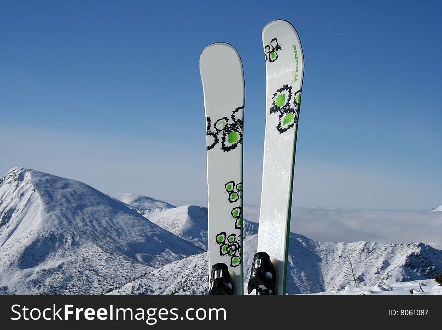 Freeride skiing in the mountain range snow against blue sky. Freeride skiing in the mountain range snow against blue sky.