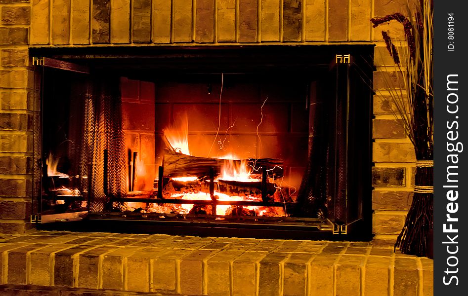 Burning wood fire in brick fireplace. Burning wood fire in brick fireplace