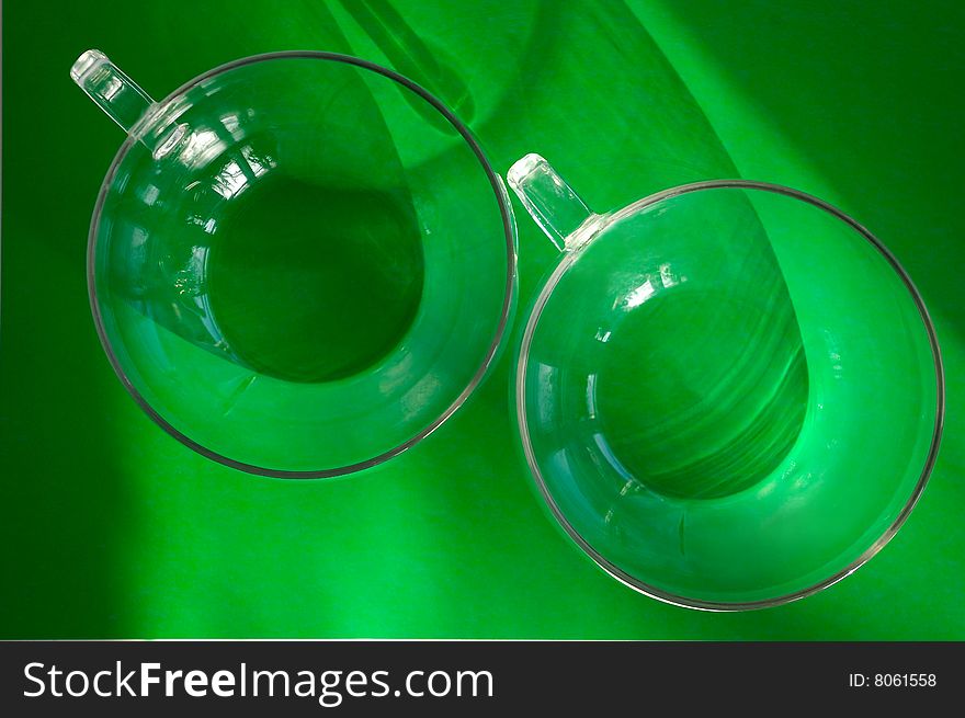 Two glasses against the green background