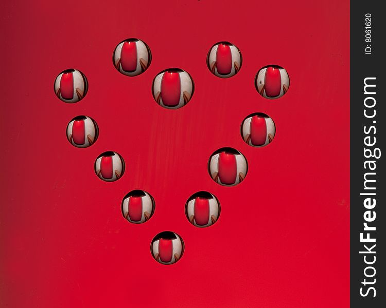 Water drops in the form of heart on a celebratory background