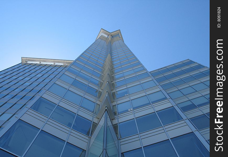 A tall modern glass building. A tall modern glass building