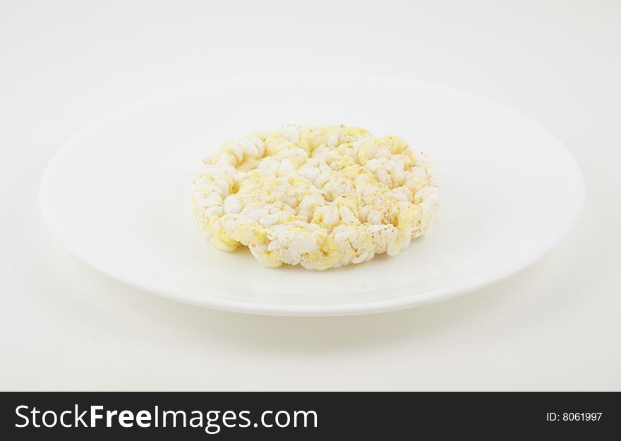 Rice cake on a white plate.  The ultimate low calorie food.