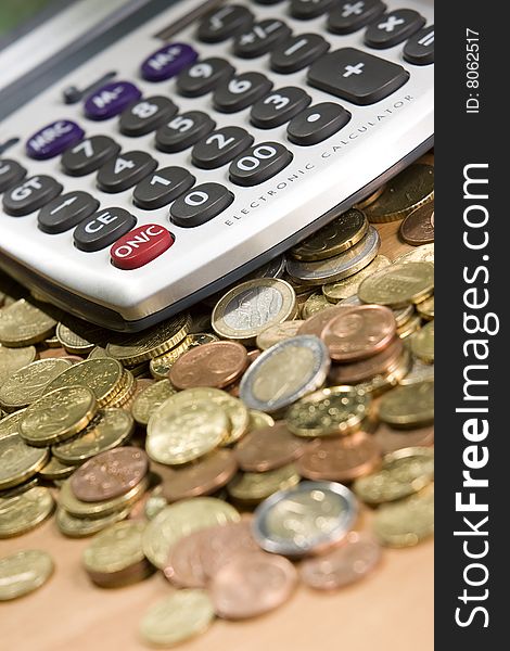 Pocket calculator and euro coins on table