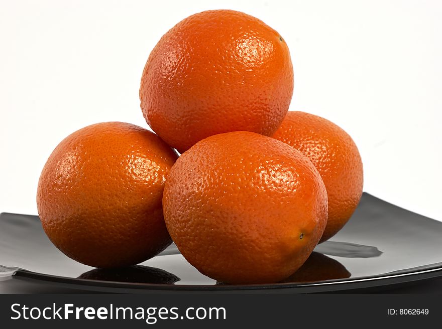 Fresh Oranges on black plate