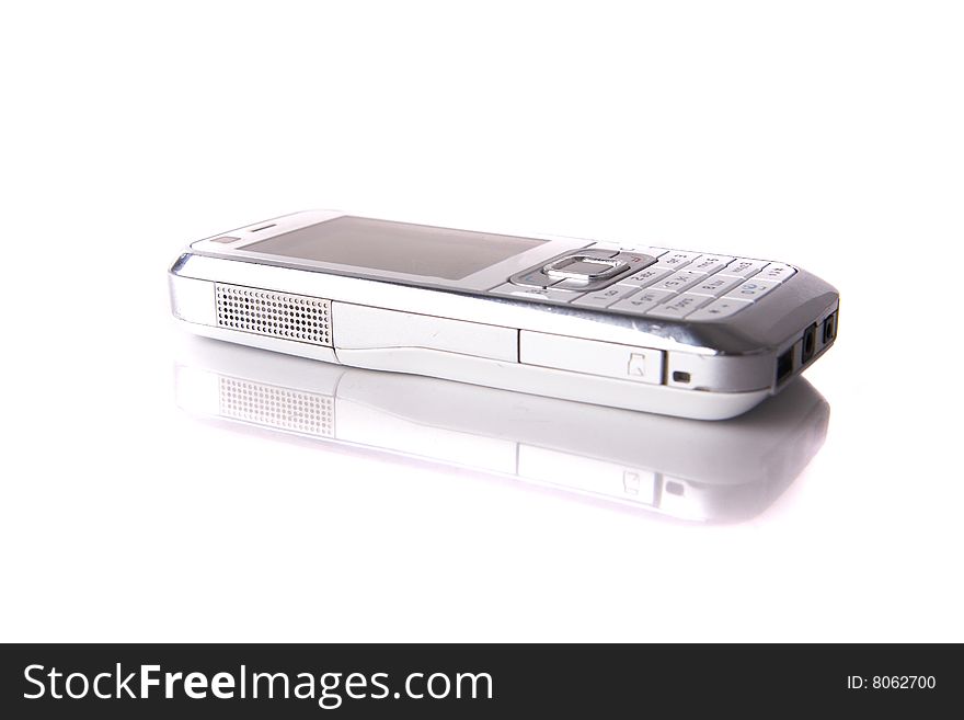 Isolated shot of a white cell phone. The phone is mirrored and isolated over pure white. Lot of copyspace. Isolated shot of a white cell phone. The phone is mirrored and isolated over pure white. Lot of copyspace.