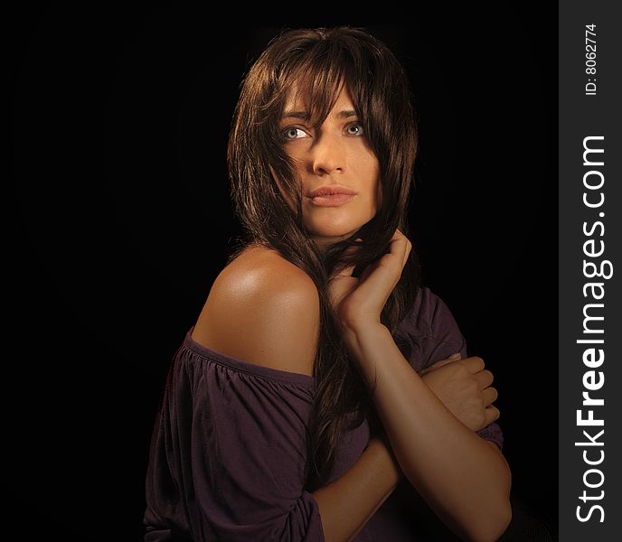 Beautiful brunette woman on black background