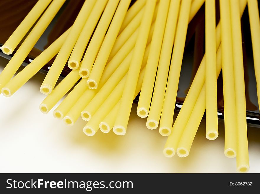 Uncooked pasta on black plate