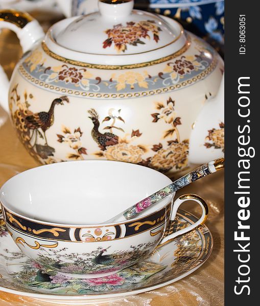 China tea cup with painted golden rim and floral ornament motifs