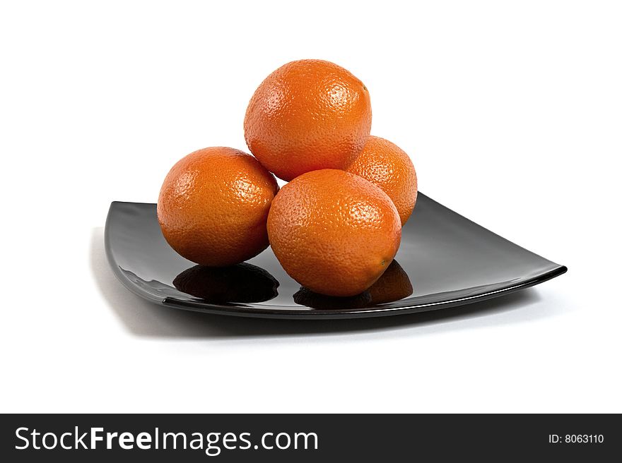 Fresh Oranges on black plate