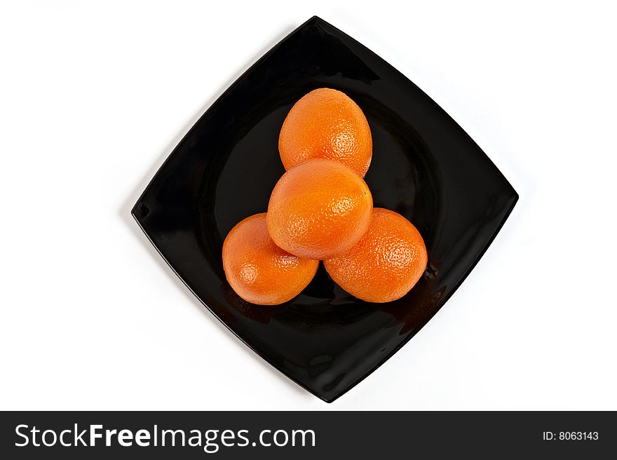 Fresh Oranges on black plate