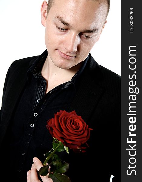 Man looking a rose on a with background. Man looking a rose on a with background