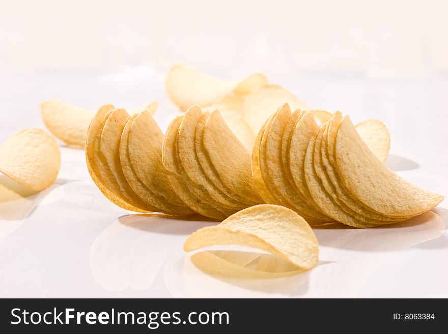 Food series: golden potato chips over white. Food series: golden potato chips over white