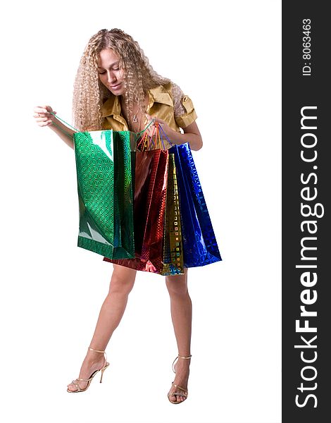 The young beautiful girl with purchases in colour packages during shopping on a white background