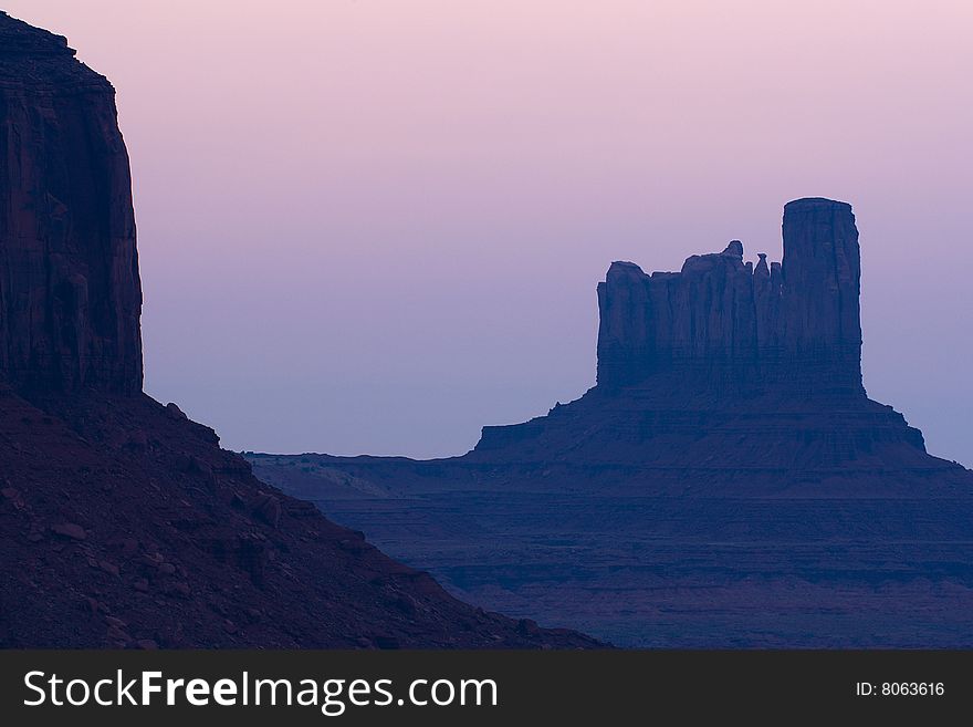 Dawn light over one of the rock formations in Monument Valley. Dawn light over one of the rock formations in Monument Valley