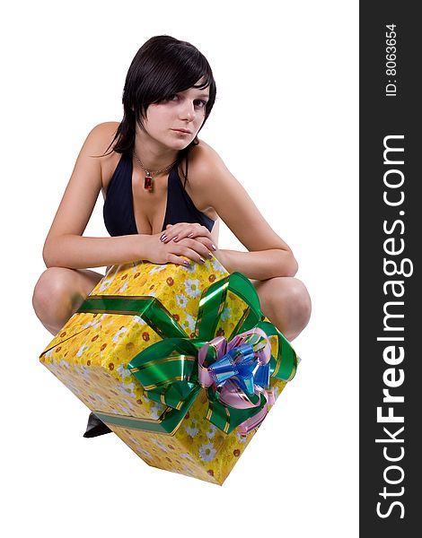 The young beautiful girl with a gift box on a white background