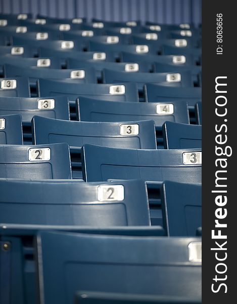 Looking up at empty blue seats at a baseball stadium. Looking up at empty blue seats at a baseball stadium