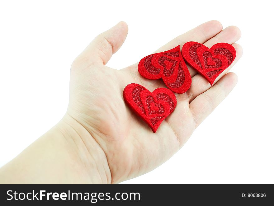 Men's hand holding three hearts isolated on a white background