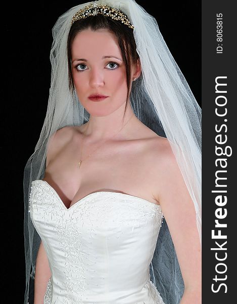 Beautiful bride in her wedding dress looking directly into the camera with a suttle expression. Beautiful bride in her wedding dress looking directly into the camera with a suttle expression.