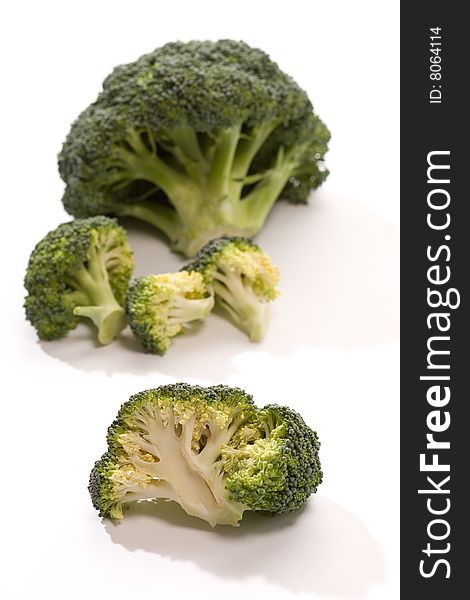 Macro picture, two heads of broccoli over white