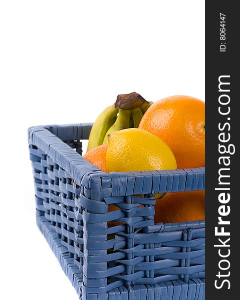 Blue basket with fruits on white background
