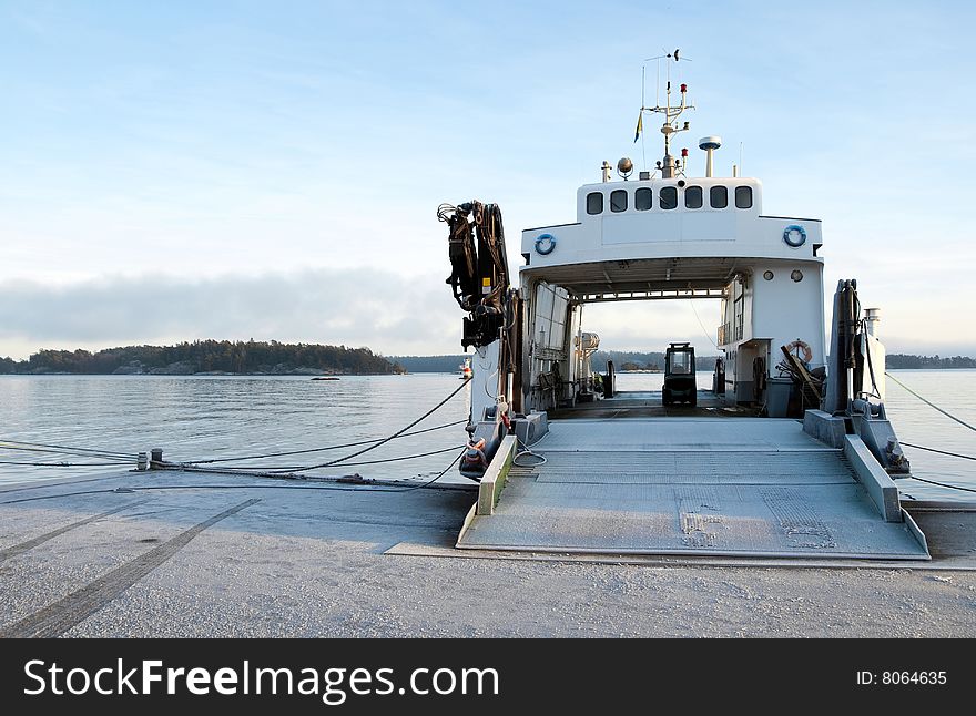 Small ferryboat moored at quay on a calm evening.