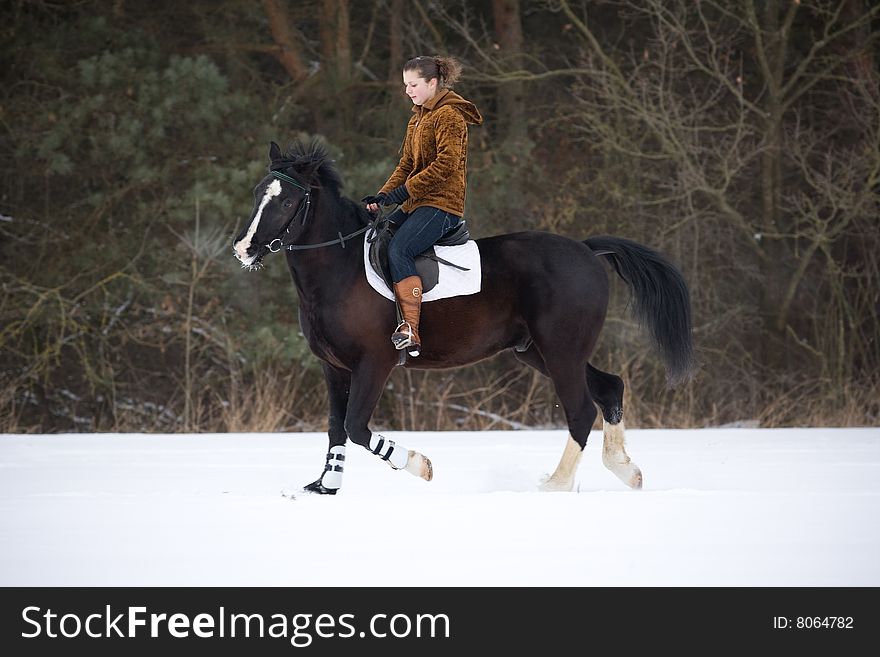 The girl is riding a horse