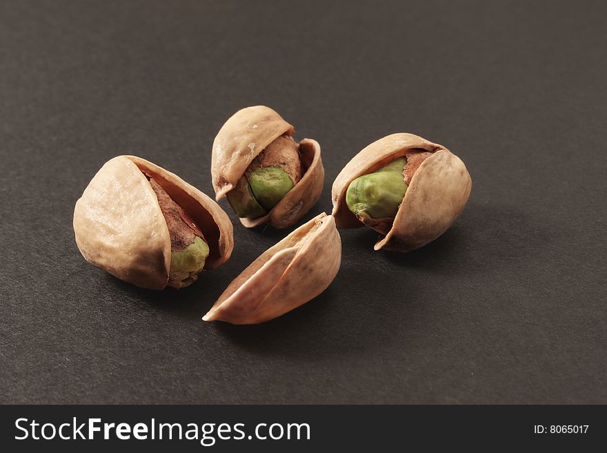 Group of pistachios, on the dark background. Group of pistachios, on the dark background