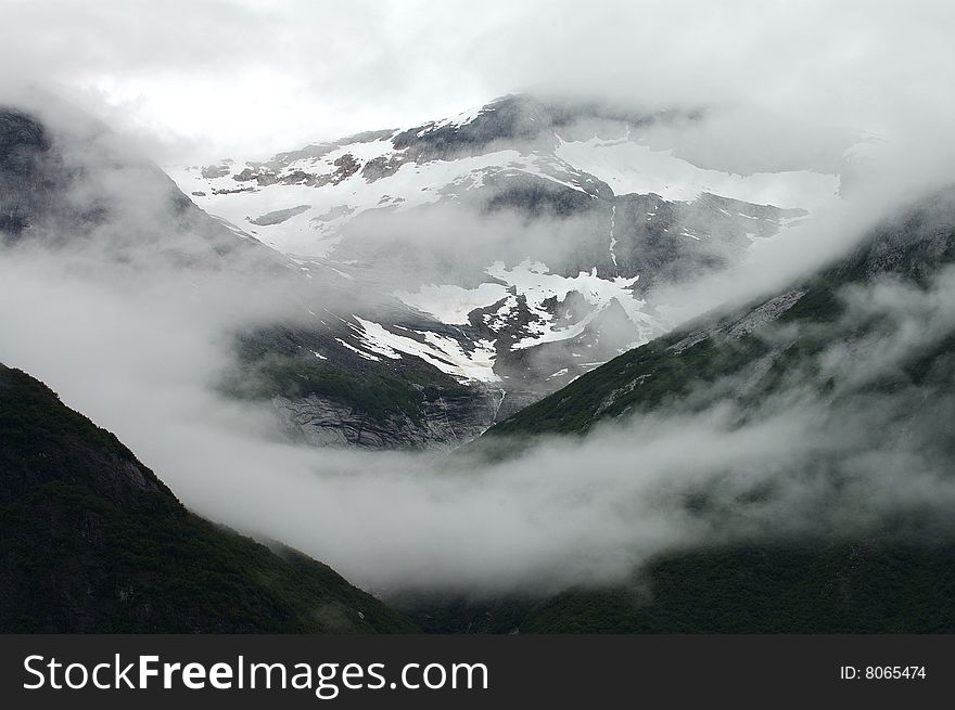 Clouds over mountains in the Tracy Arm Passage of Alaska. Clouds over mountains in the Tracy Arm Passage of Alaska