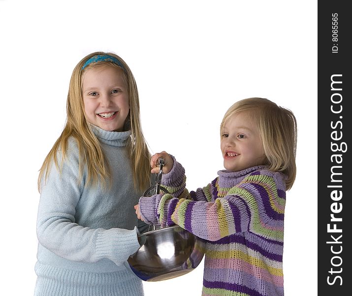 Sisters mixing and baking isolated on a white background