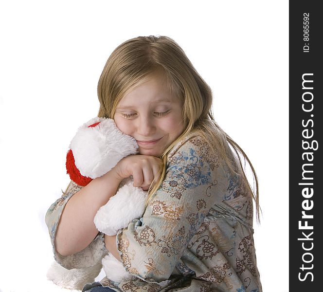 Girl hugging stuffed animal on white background