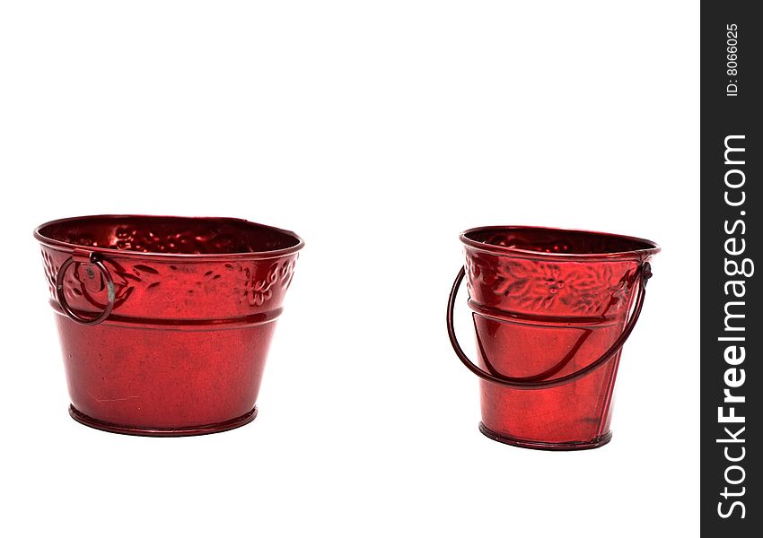 Two miniature red metal buckets on white background.