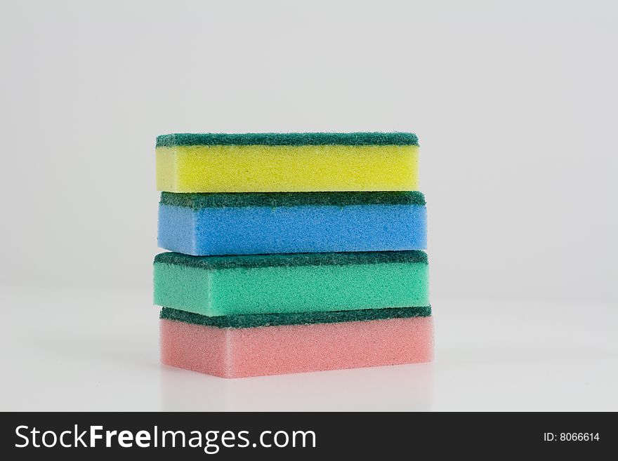 Heap of colorful sponges on a white background