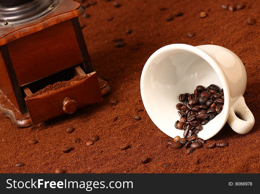 Detail of coffee grinder on brown background