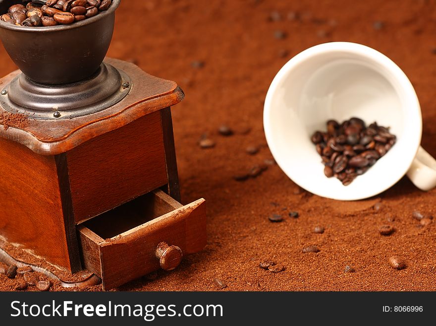 Detail of coffee grinder on brown background