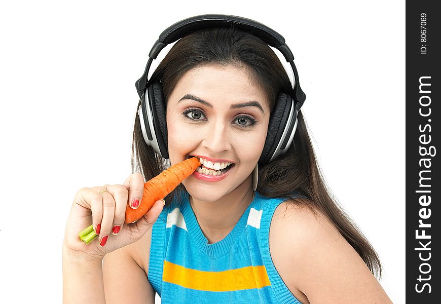 Beautiful young woman eating a carrot. Beautiful young woman eating a carrot