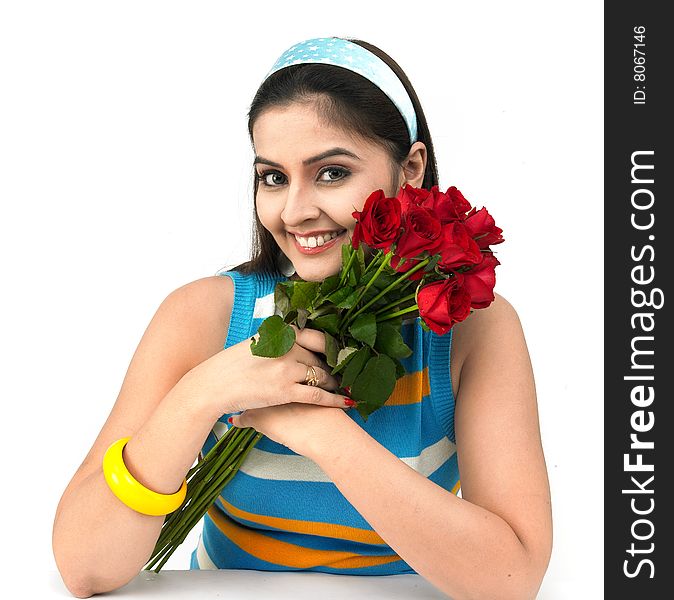 A smiling woman with a bouquet of red roses. A smiling woman with a bouquet of red roses