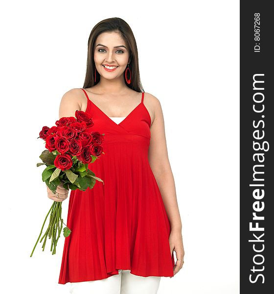 A smiling woman with a bouquet of red roses. A smiling woman with a bouquet of red roses