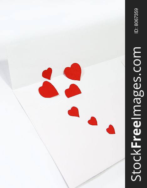 White envelope and red hearts over white. White envelope and red hearts over white