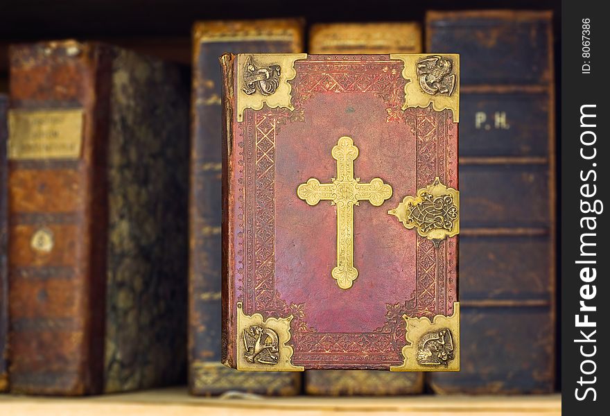 Old books and gilded Holy Bible