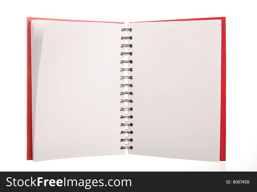 A red spiral notebook isolated on white, blank pages to put your own text or messages on
