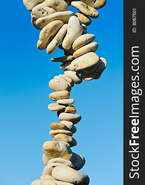 Column from a sea pebble against the pure sky. Column from a sea pebble against the pure sky