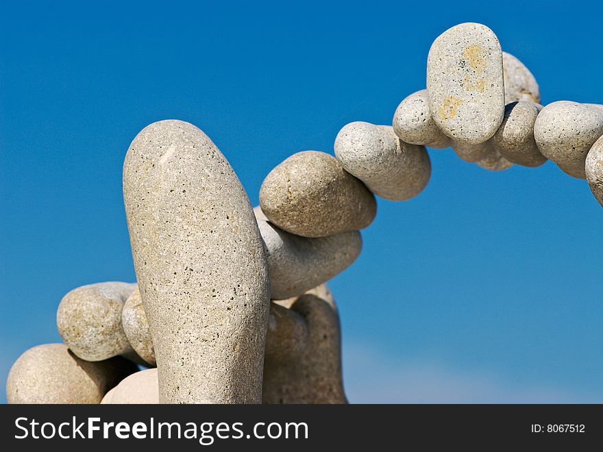 Sea pebble combined in the form of an arch against the sky. Sea pebble combined in the form of an arch against the sky