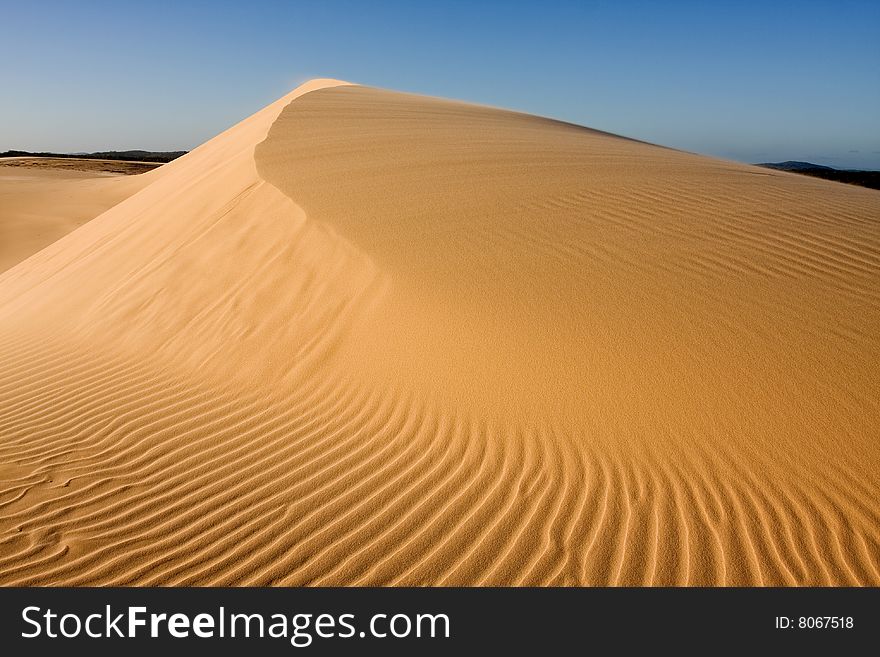 Stockton sand dunes in Anna Bay, NSW, Australia. Sand ripples detail with dramatic shadows. Taken in clear day conditions.